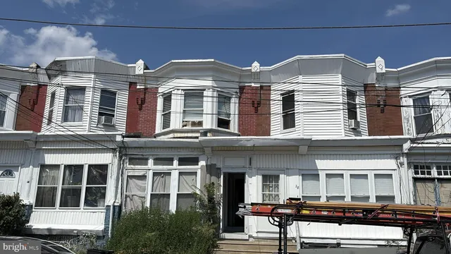 a front view of a building with a yard