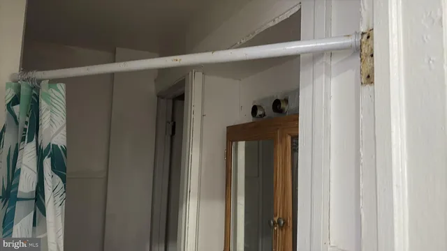 a view of hall way with mirror and stairs