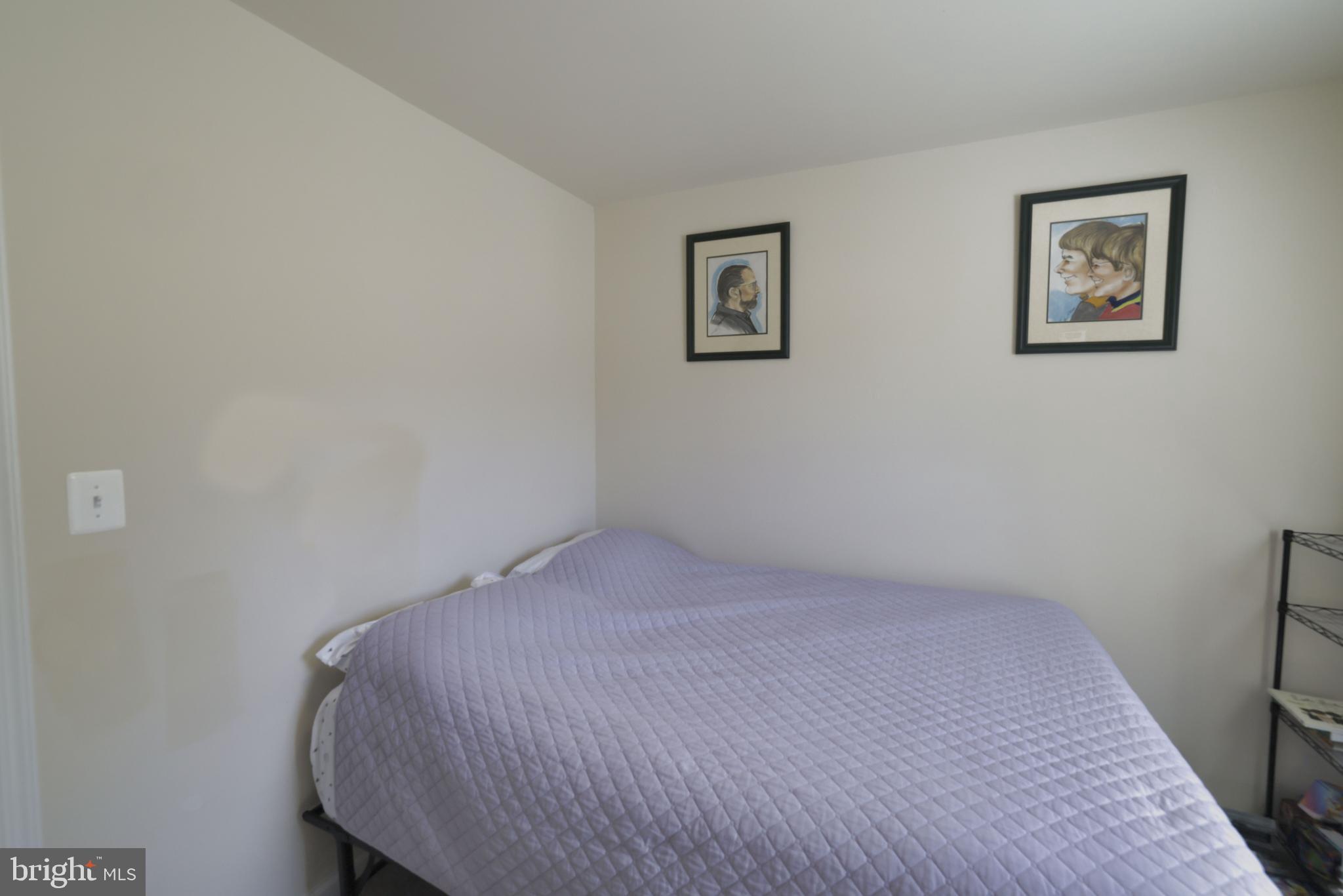 48 Rustic Lane Colonial Beach, VA 22443 - Photo 38 of 47 a bedroom with a bed and painting on the wall