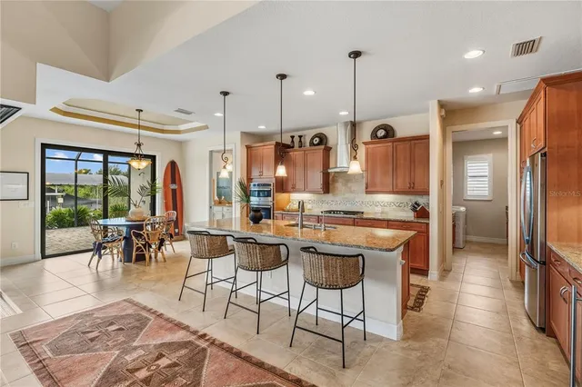 a large kitchen with a table and chairs