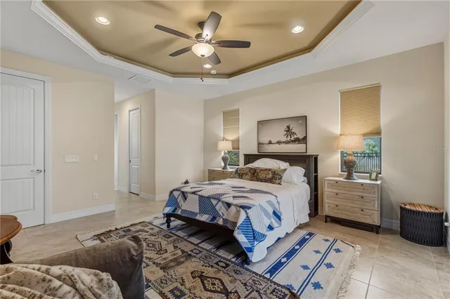 a bedroom with a large bed and a chandelier