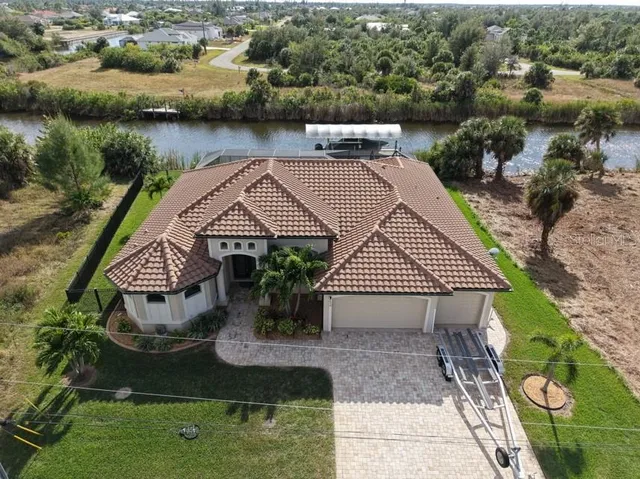 an aerial view of a house with garden space and lake view