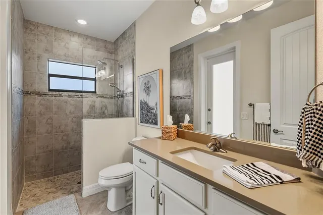 a bathroom with a sink toilet and shower