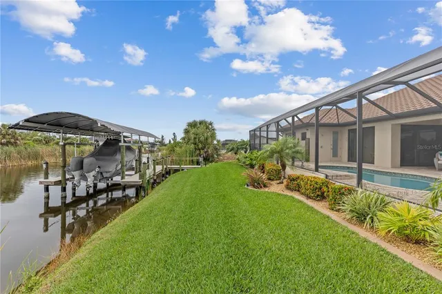 a view of a house with swimming pool and sitting area