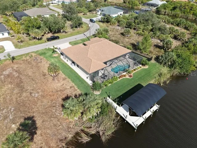 an aerial view of a house with a yard