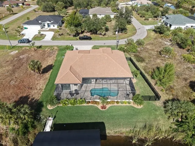 an aerial view of a house with yard swimming pool and outdoor seating