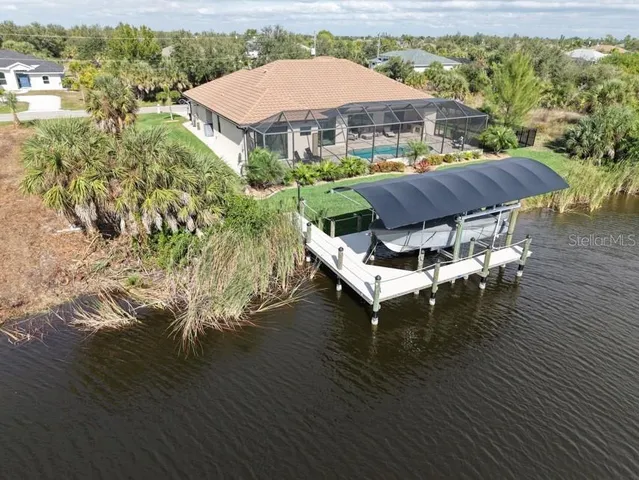 a view of a patio with table and chairs under an umbrella