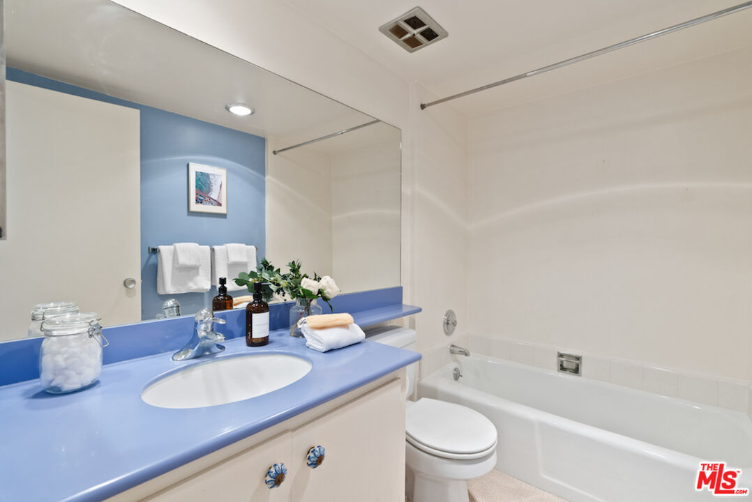 852 21st Street, Unit E Santa Monica, CA 90403 - Photo 17 of 20 a bathroom with a granite countertop sink mirror toilet and bathtub