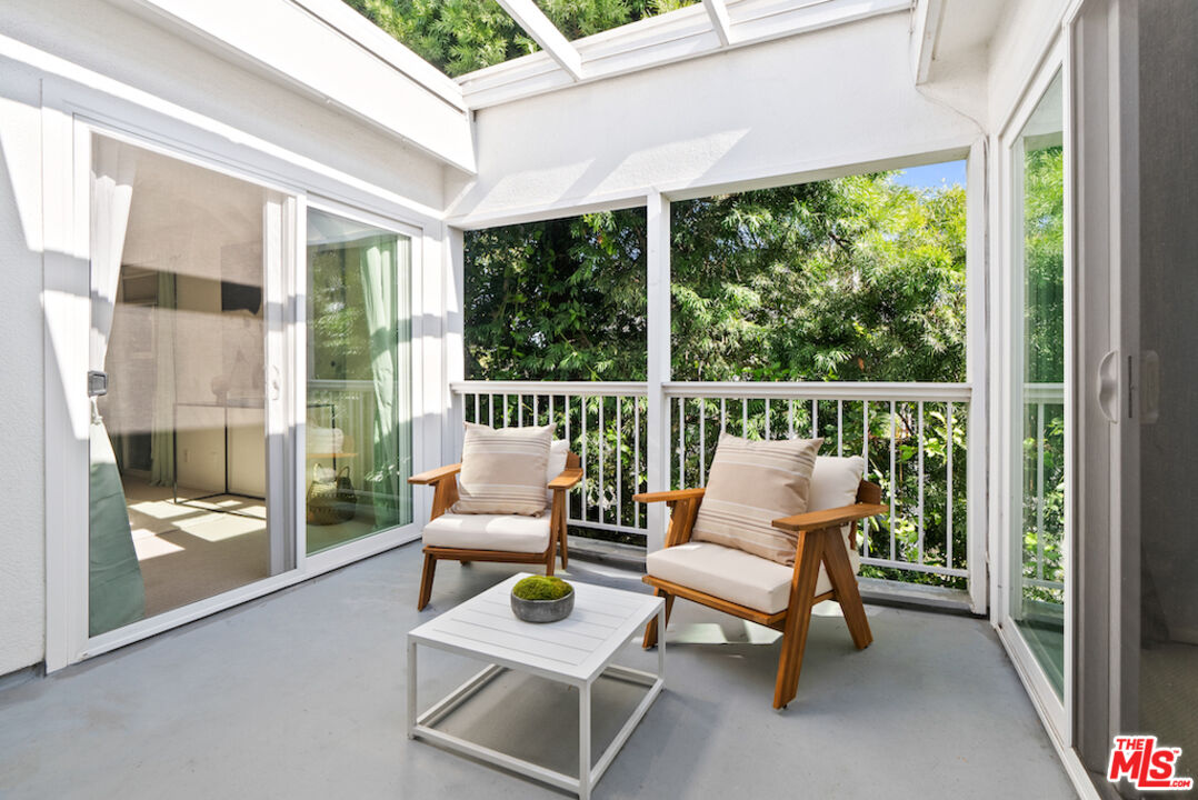 852 21st Street, Unit E Santa Monica, CA 90403 - Photo 18 of 20 a balcony with couple of chairs and a couch
