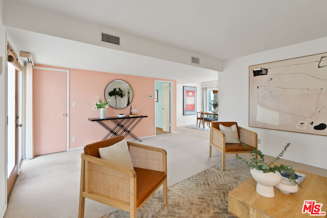 852 21st Street, Unit E Santa Monica, CA 90403 - Photo 5 of 20 a living room with furniture a rug and white walls