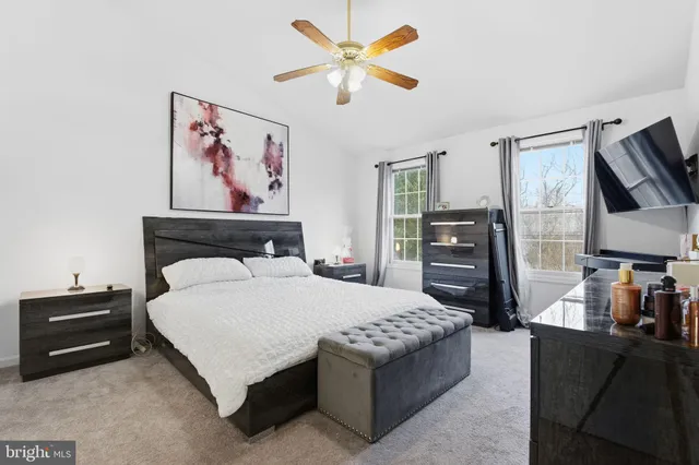 a bedroom with a bed and dresser