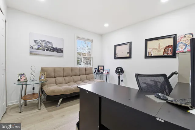 a living room with furniture potted plant and a window