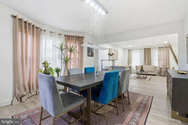 a view of a dining room with furniture and a potted plant