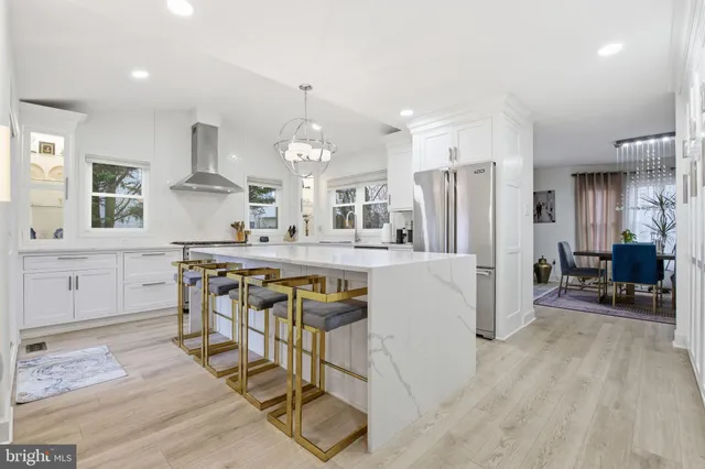 a large kitchen with a table and chairs