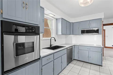 a kitchen with cabinets appliances and a sink