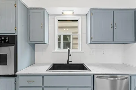 a kitchen with sink cabinets and window