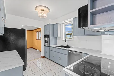 a kitchen with stainless steel appliances granite countertop a sink and a stove