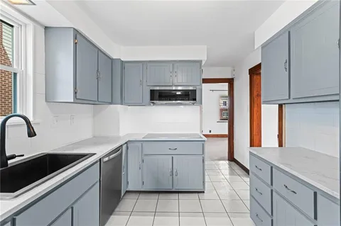 a kitchen with a sink stove and cabinets
