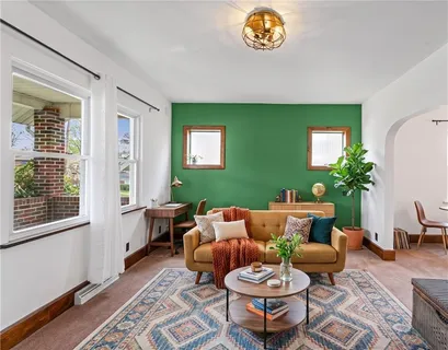 a living room with furniture a rug and a window