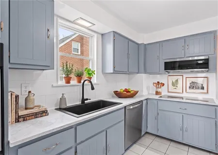 a kitchen with stainless steel appliances granite countertop a sink a stove and cabinets