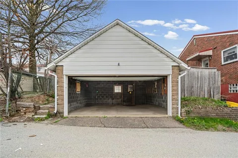 a front view of a house with a garden and entryway