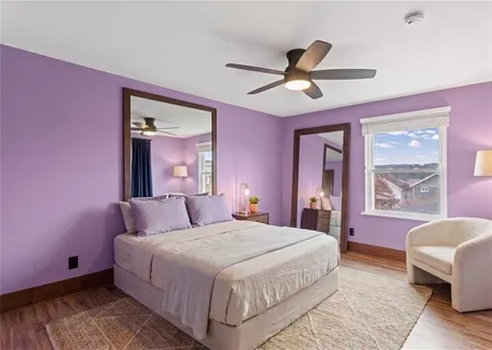 a bedroom with a large bed and a chandelier