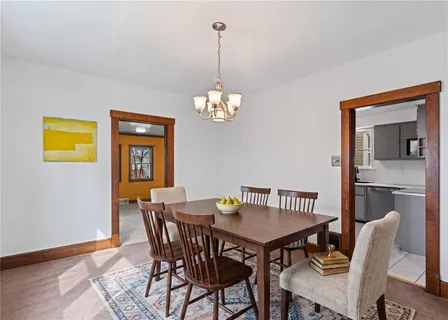 a view of a dining room with furniture wooden floor and a chandelier