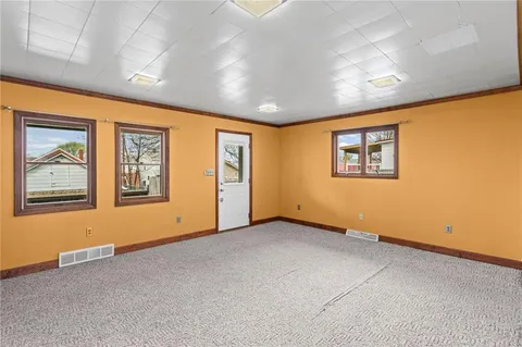 a view of an empty room with windows