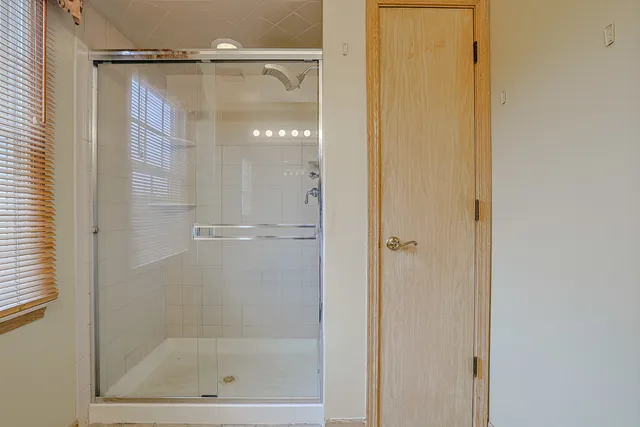 a bathroom with a glass shower door