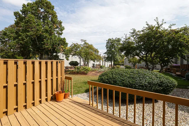 a balcony with wooden floor and fence