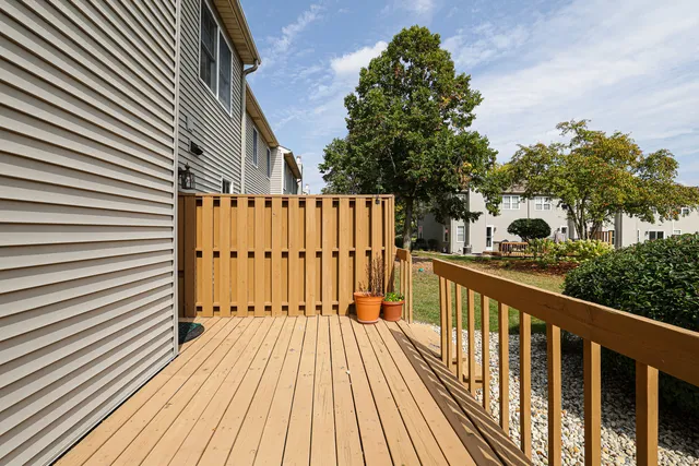 a view of balcony with wooden floor and fence