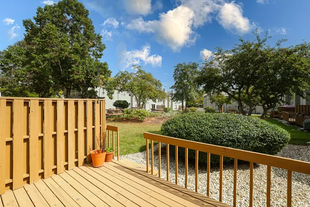 a balcony with wooden floor and fence
