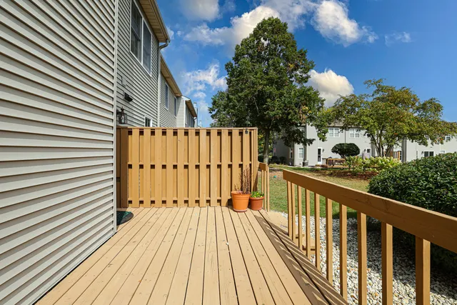 a view of balcony with wooden floor and fence