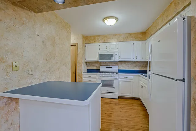 a kitchen with stainless steel appliances a refrigerator sink and cabinets