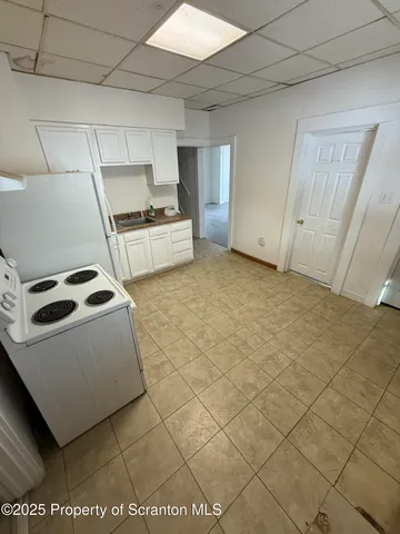 a kitchen with a sink a stove and cabinets