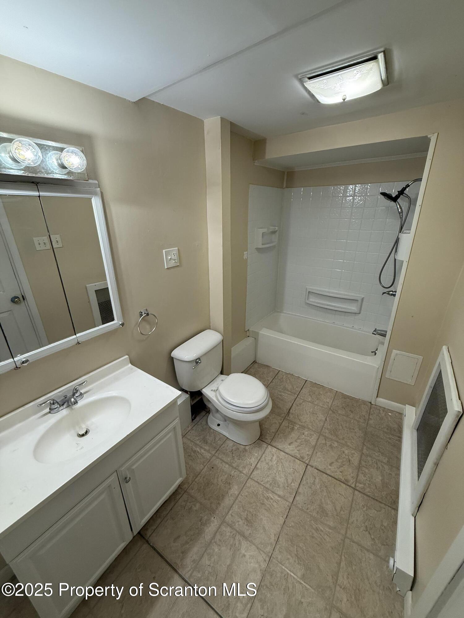 333 Spring Street Scranton, PA 18508 - Photo 6 of 8 a bathroom with a sink a toilet and shower