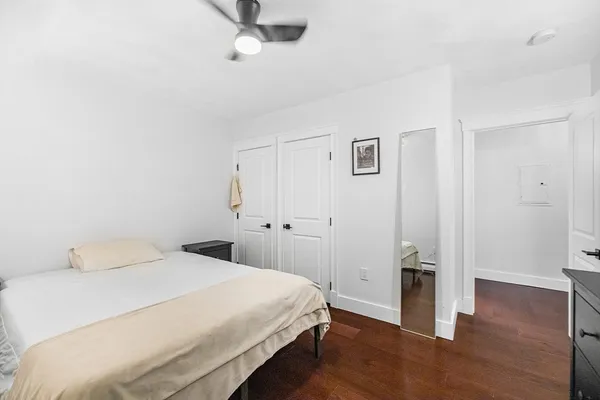 a bedroom with a bed and wooden floor