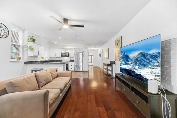 a living room with furniture and kitchen view