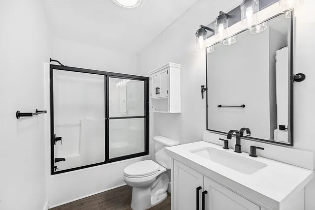 a bathroom with a sink toilet and shower