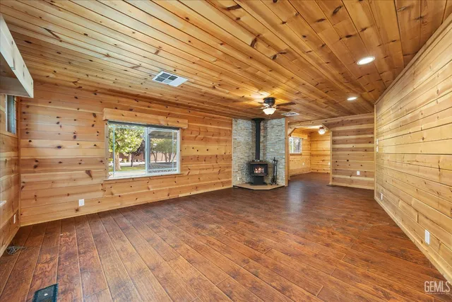 a large kitchen with stainless steel appliances granite countertop a stove and a refrigerator