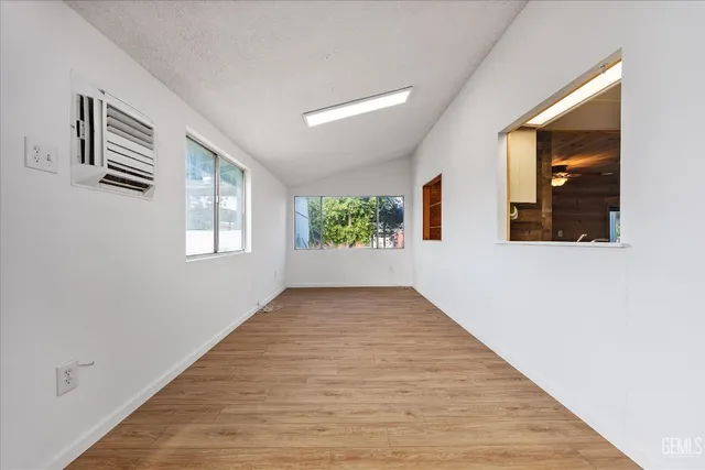 a view of a kitchen with furniture wooden floor ceiling fan and windows