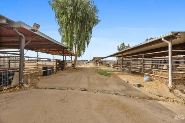 a view of a terrace with a table and chairs under an umbrella