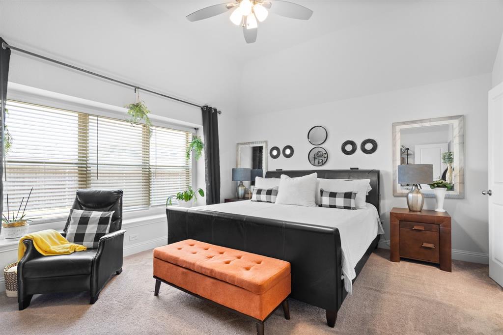 3724 Ranchers Ridge Krum, TX 76249 - Photo 16 of 32 Spacious primary bedroom featuring oversizedwindows, plush carpeting, and a walk-in closet!