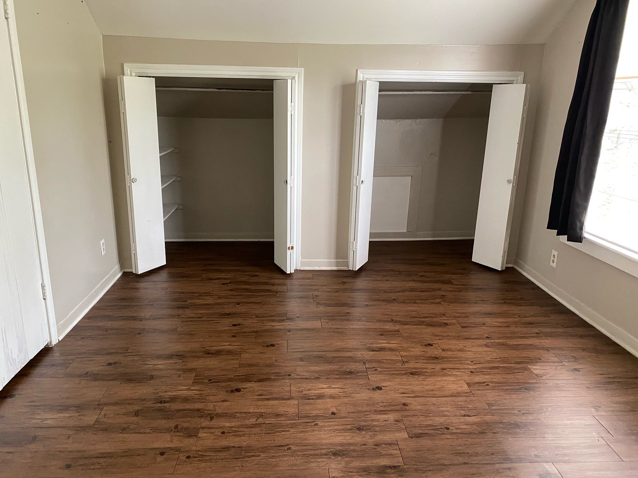 800 Travis Street, Unit ATTIC Columbus, TX 78934 - Photo 7 of 9 an empty room with wooden floor and closet