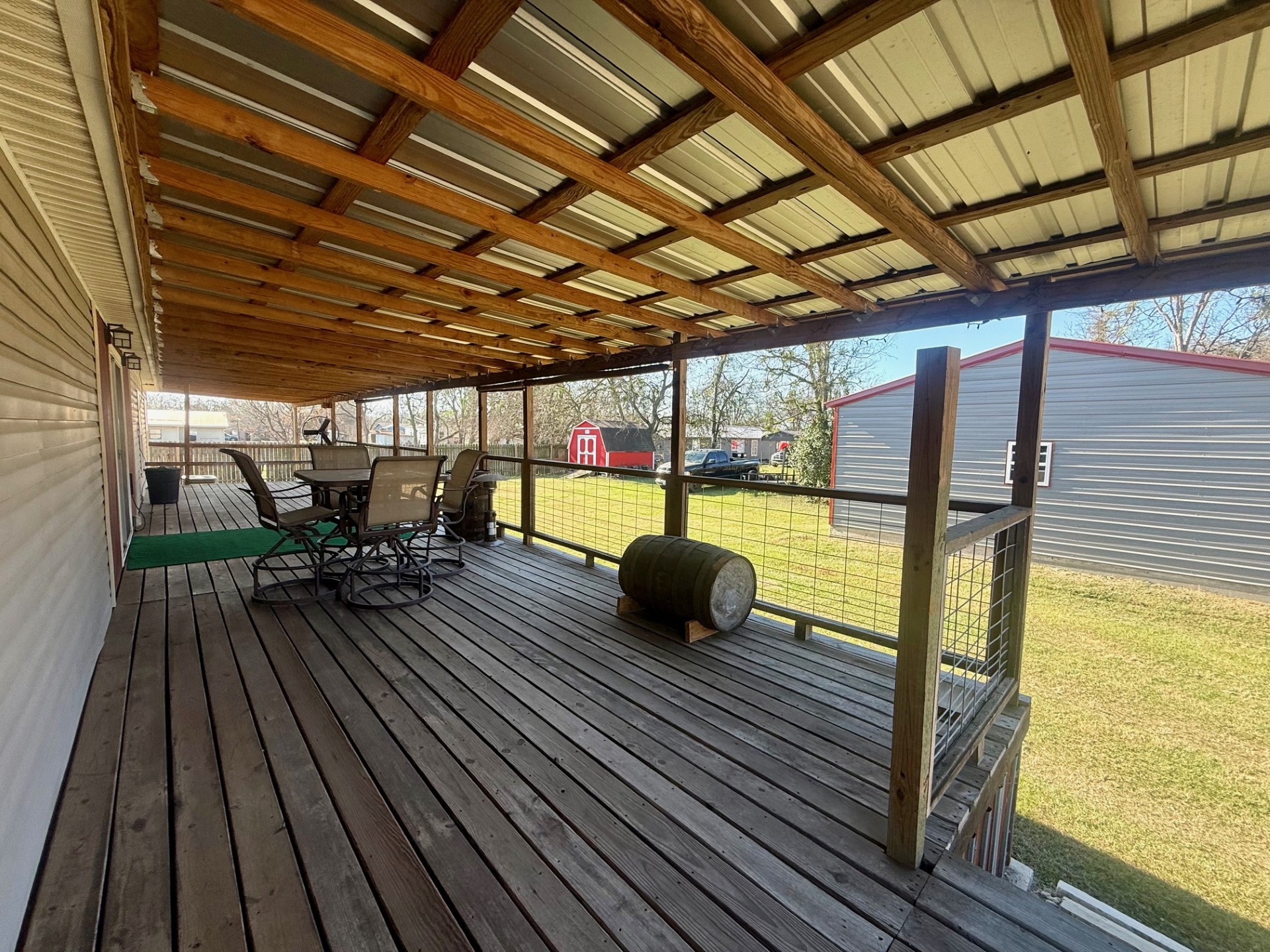 845 Caldwell Street Lexington, TX 78947 - Photo 36 of 39 Wooden terrace with a lawn and outdoor dining space