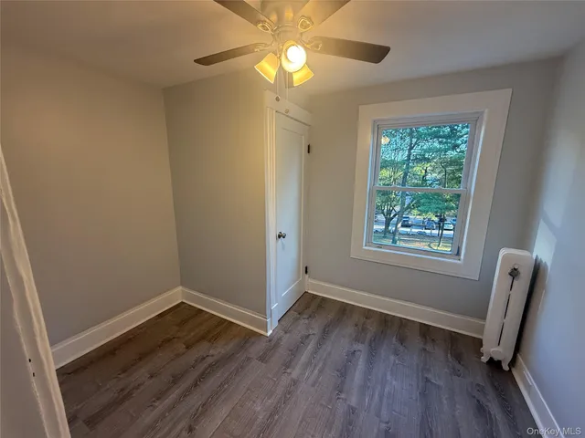 a view of room with window and wooden floor