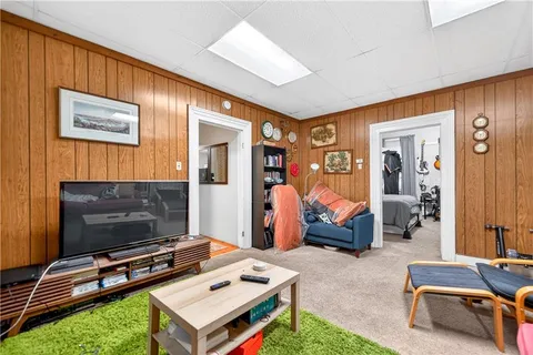 a bedroom with a bed couch and a window