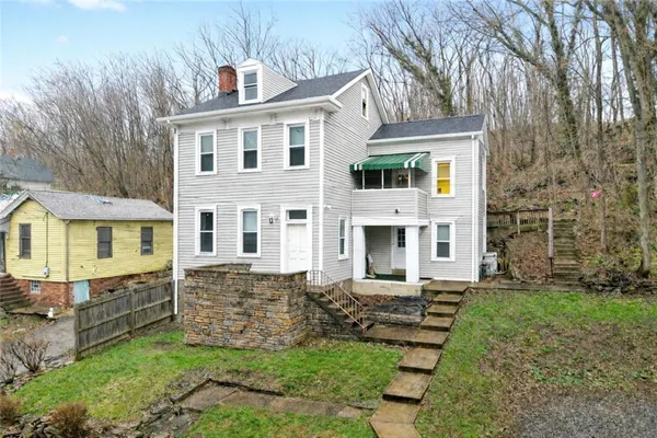 a view of house with yard
