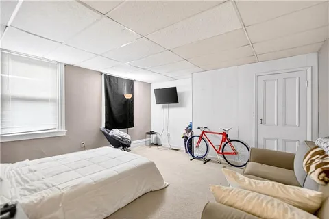 a spacious bedroom with a bed and a couch
