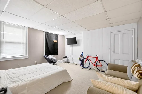 a spacious bedroom with a bed and a couch